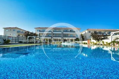 a large swimming pool in front of a building at Sunny 2Br Family Apartment - Mythical Sands Resort in Protaras