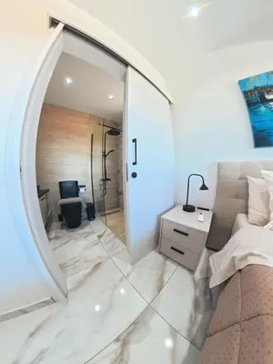 a bedroom with a large mirror and a bed at Mediterranean Sunrise Villa Protaras in Paralimni