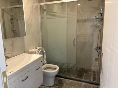 a bathroom with a shower and a toilet and a sink at Veray Homes in Nicosia