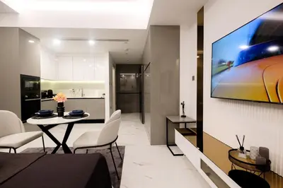 a living room with a table and chairs and a kitchen at Panorama Comfort Nest in Paralimni