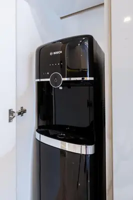 a toaster oven sitting on a stand next to a door at Panorama Comfort Nest in Paralimni