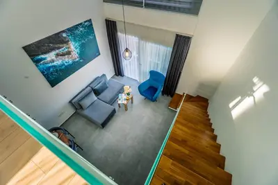 an overhead view of a living room with blue furniture at Stylish Loft - 50m from Beach in Paralimni