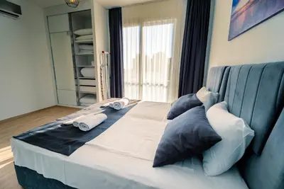 a large bed with pillows on it in a room at Stylish Loft - 50m from Beach in Paralimni