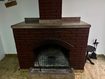 a red brick fireplace with a brick at ARTEMIS HOUSe in Kakopetria