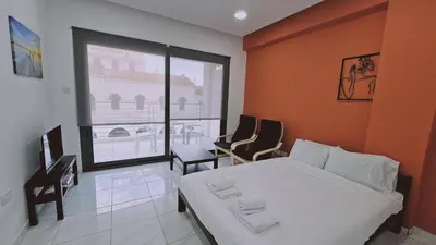 a bedroom with a white bed and a large window at STAY Terra Cota Studio in Limassol