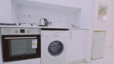 a kitchen with a washing machine and a counter at STAY Terra Cota Studio in Limassol