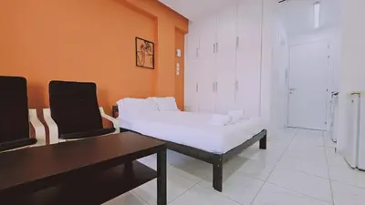 a bedroom with a bed and a table and chairs at STAY Terra Cota Studio in Limassol