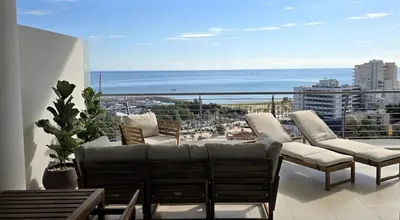 a balcony with couches and a view of the ocean at Breathtaking Sea and Marina View City Center 2 bdr in Larnaka