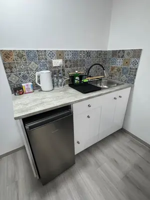 a kitchen with a sink and a counter top at Limassol center Soul in Limassol