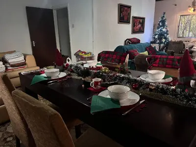 a living room with a table with christmas decorations at Mountain Retreat in Kakopetria, Cyprus - Perfect for Families in Kakopetria