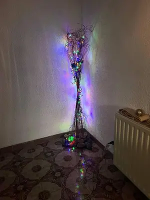 a vase with flowers in a room with lights at Mountain Retreat in Kakopetria, Cyprus - Perfect for Families in Kakopetria