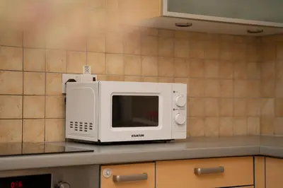a microwave sitting on top of a kitchen counter at 2 bedroom flat in center in Nicosia