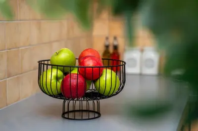 a basket of apples and other fruits on a counter at 2 bedroom flat in center in Nicosia