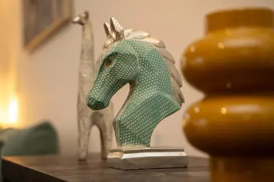 a green plastic horse statue sitting on a table at 2 bedroom flat in center in Nicosia