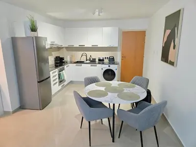 a kitchen with a table and chairs in a room at Thea Court 1 - A in Paralimni