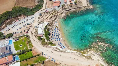 an aerial view of a beach with umbrellas and the ocean at Thea Court 1 - A in Paralimni