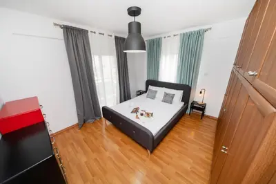 a bedroom with a bed with a dog on it at 2 bedroom flat in Strovolos