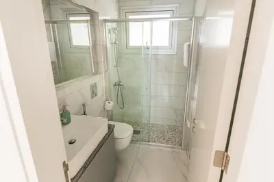 a bathroom with a shower and a toilet and a sink at Mythical Sands 2 - E in Paralimni