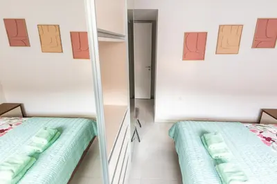 a room with a mirror next to a bed at Mythical Sands 2 - E in Paralimni