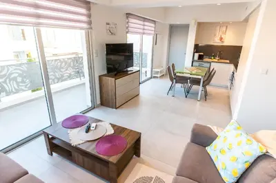 a living room with a couch and a table at Mythical Sands 2 - E in Paralimni