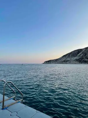 a boat in the middle of a large body of water at Stunning villa with breathtaking sea view in Pissouri