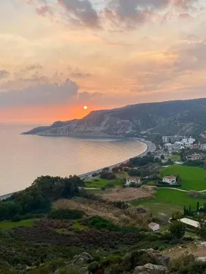 a view of the ocean with the sunset in the background at Stunning villa with breathtaking sea view in Pissouri