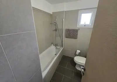 a bathroom with a tub and a toilet and a shower at Thea Court 3 - E in Paralimni