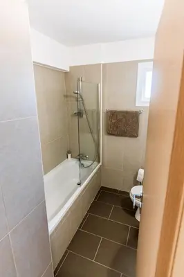a bathroom with a bath tub and a toilet at Thea Court 3 - E in Paralimni