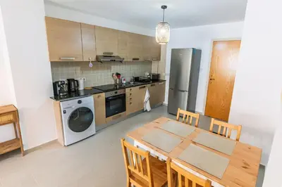 a kitchen with a dining room table and a refrigerator at Thea Court 3 - E in Paralimni