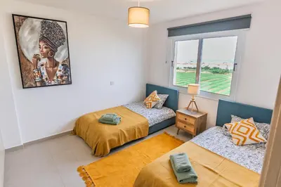 a room with three beds and a window at Thea Court 3 - E in Paralimni