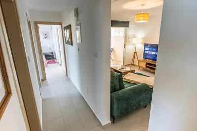a hallway leading to a living room with a green couch at Thea Court 3 - E in Paralimni