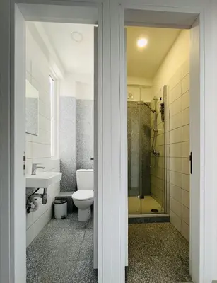 a bathroom with a toilet and a sink and a shower at Unique 2 storey apt city centre in Larnaka