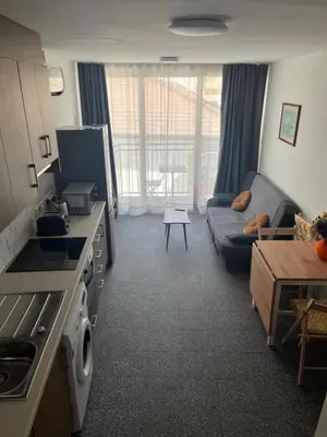 a kitchen and living room with a couch and a table at Unique 2 storey apt city centre in Larnaka