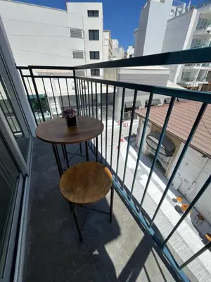 a table and a chair on a balcony at Unique 2 storey apt city centre in Larnaka