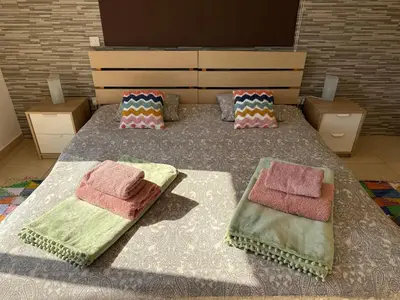 a bedroom with a bed with two blankets and pillows at Nissia Bella 1 - A in Ayia Napa