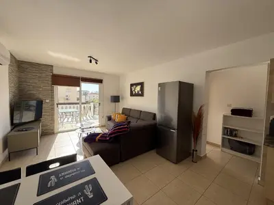 a living room with a couch and a refrigerator at Nissia Bella 1 - A in Ayia Napa