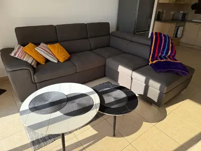 a living room with a couch and a table at Nissia Bella 1 - A in Ayia Napa