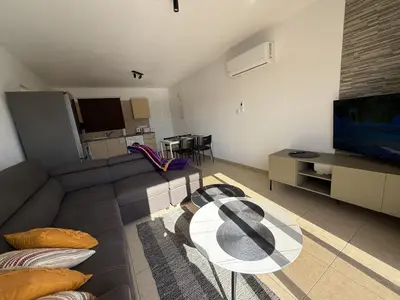 a living room with a couch and a table at Nissia Bella 1 - A in Ayia Napa