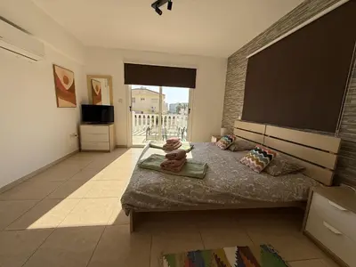 a bedroom with a bed and a large window at Nissia Bella 1 - A in Ayia Napa