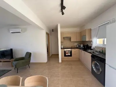a kitchen and living room with a washer and dryer at Nissi 3, 1 -B in Ayia Napa