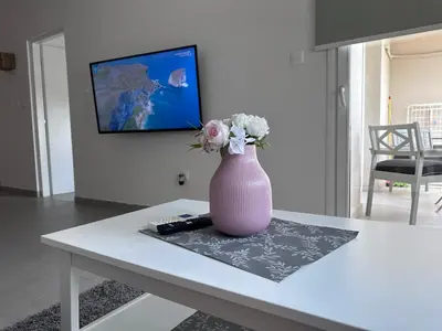 a pink vase with flowers sitting on a table at Amore 1 - A in Paralimni