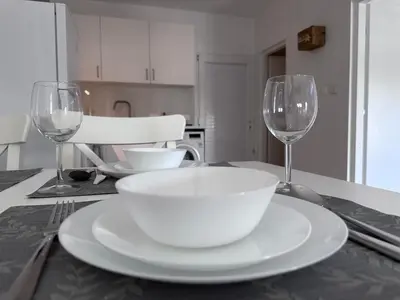 a table with two wine glasses and a white plate at Amore 1 - A in Paralimni