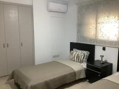 a bedroom with two beds and a window at Urban Nest - near GSP & General Hospital in Laxia