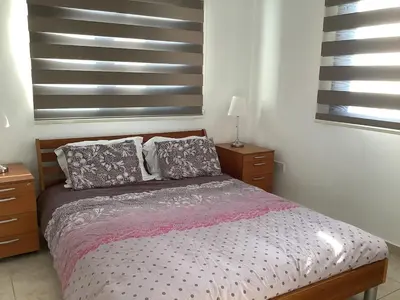 a bedroom with a bed with two pillows on it at Urban Nest - near GSP & General Hospital in Laxia
