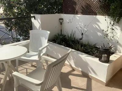 two white chairs and a table on a patio at Urban Nest - near GSP & General Hospital in Laxia