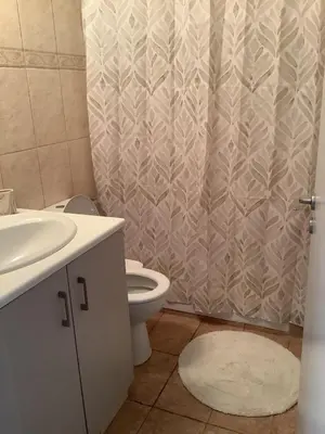 a bathroom with a toilet and a shower curtain at Urban Nest - near GSP & General Hospital in Laxia