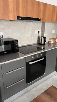 a kitchen with a microwave and a stove top oven at Sunrise 80 in Aglantzia