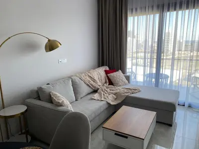 a living room with a couch and a table at Sunrise 80 in Aglantzia