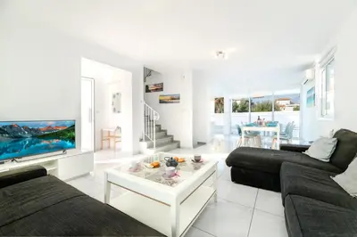 a living room with a couch and a coffee table at Green Bay Villa #12 in Protaras