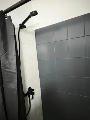 a shower in a bathroom with a black shower curtain at 103 St Lazaros View Studio in Larnaka